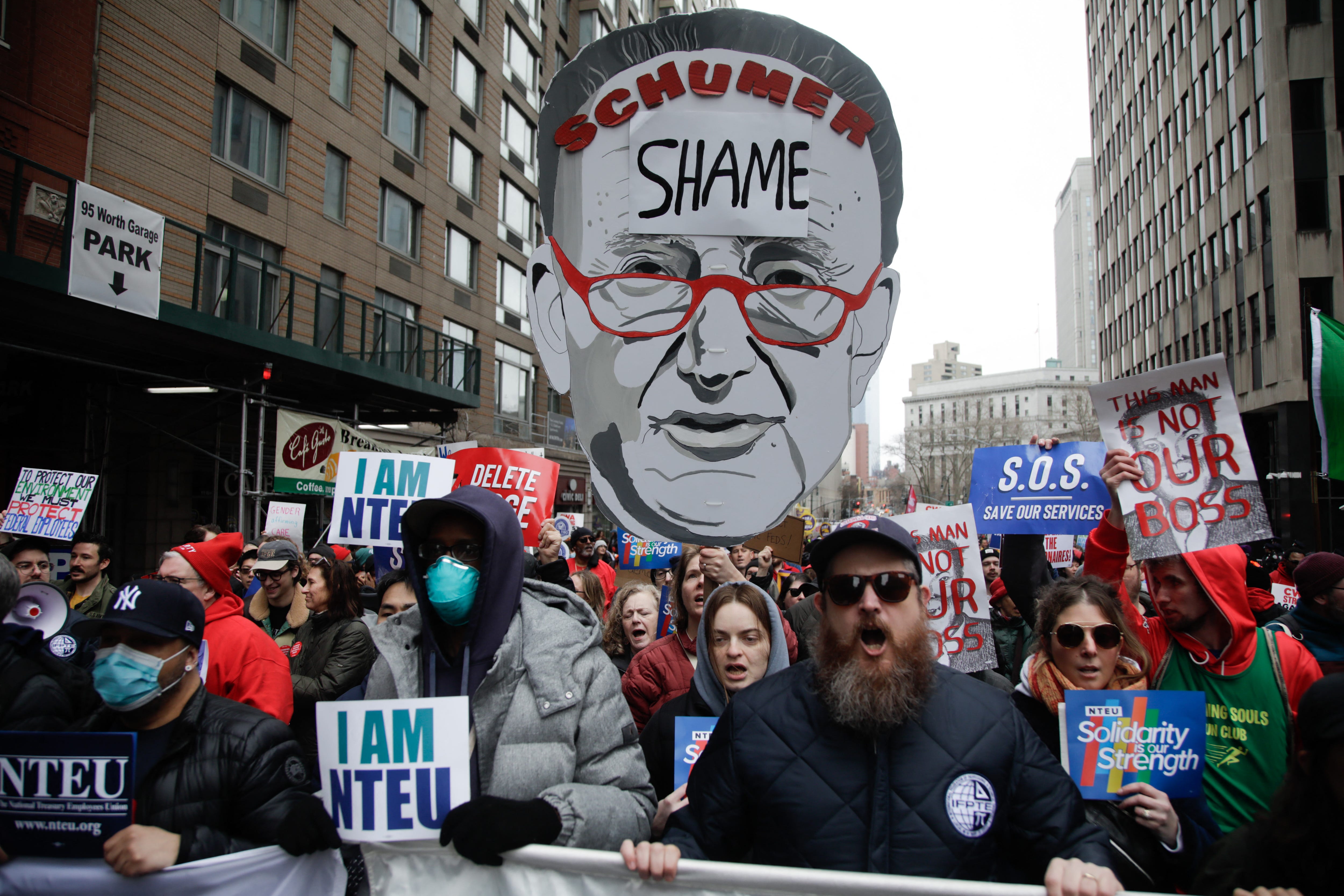 Demonstrators take part in a "March to Stop the Cuts" protest in New York on March 15, 2025. A controversial Republican spending bill passed the US Senate on March 14 with support of Minority Leader Chuck Schumer of New York and other Democratic senators.