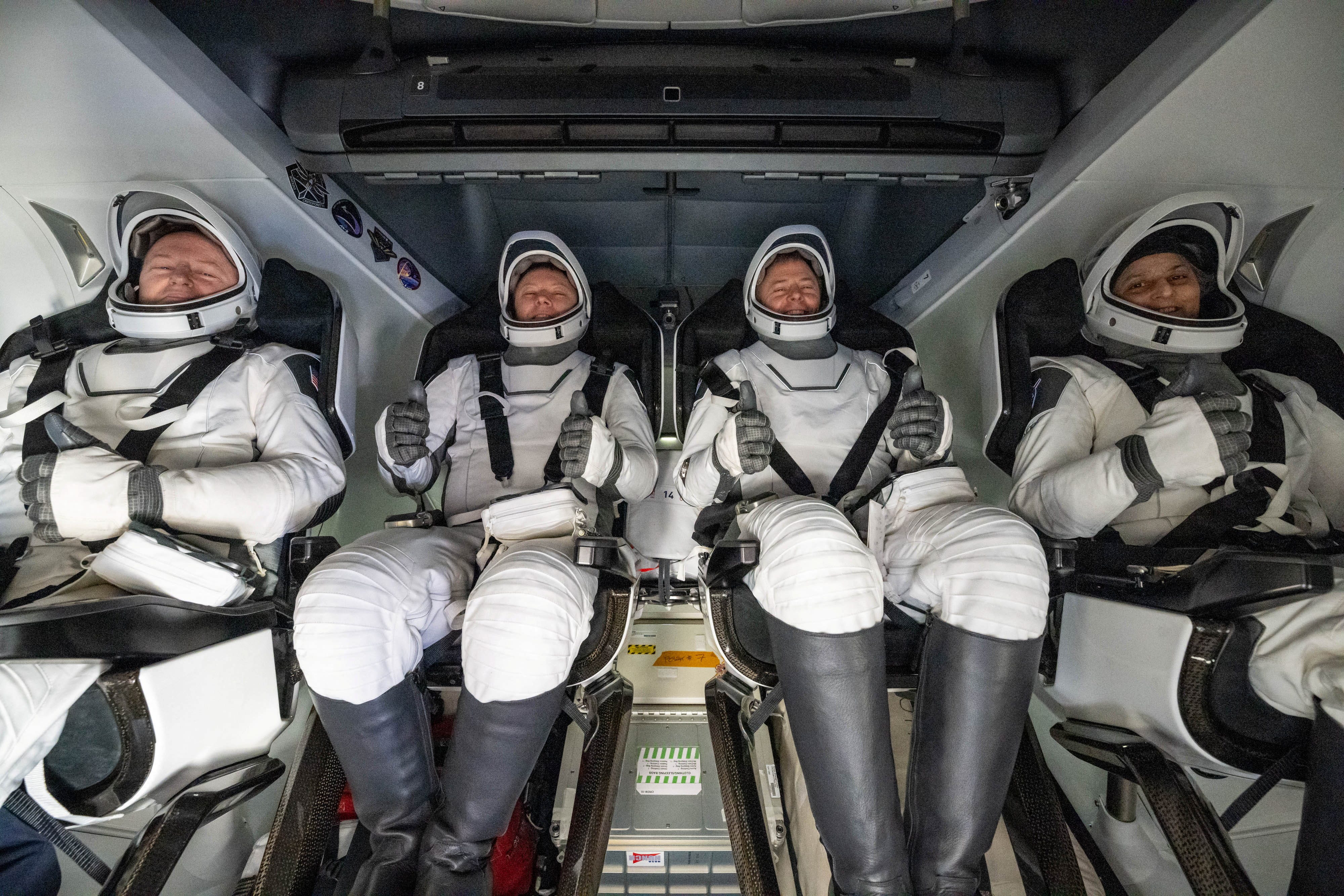 From left to right, NASA astronaut Butch Wilmore, Roscosmos cosmonaut Aleksandr Gorbunov, astronaut Nick Hague and astronaut Suni Williams are seen inside a SpaceX Dragon after the spacecraft was hoisted onto a recovery ship after landing Tuesday evening in the water off the coast of Tallahassee, Florida.