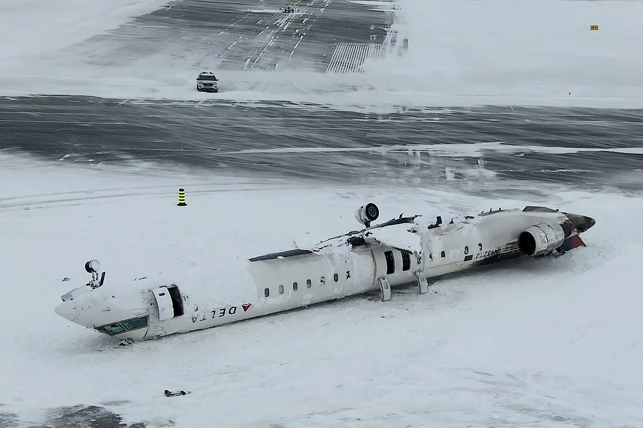 A drone view of the wreckage of a Delta Air Lines operated CRJ-900 aircraft lies crashed on the runway at Toronto Pearson International Airport in Mississauga, Ontario, Canada February 18, 2025 in a still image from video. TSB/Handout via REUTERS  THIS IMAGE HAS BEEN SUPPLIED BY A THIRD PARTY