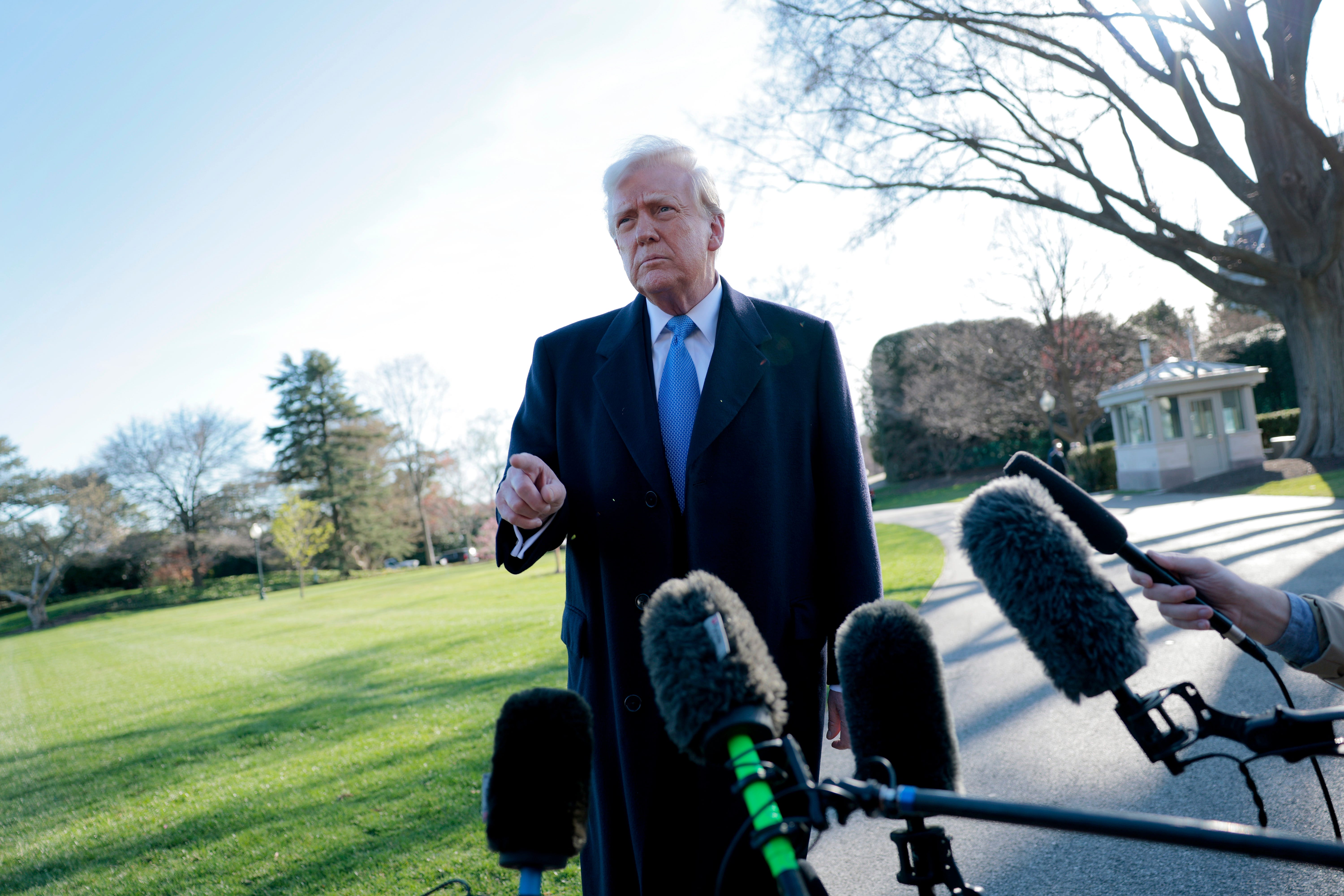 President Donald Trump speaks to reporters before boarding Marine One at the White House on March 21, 2025.