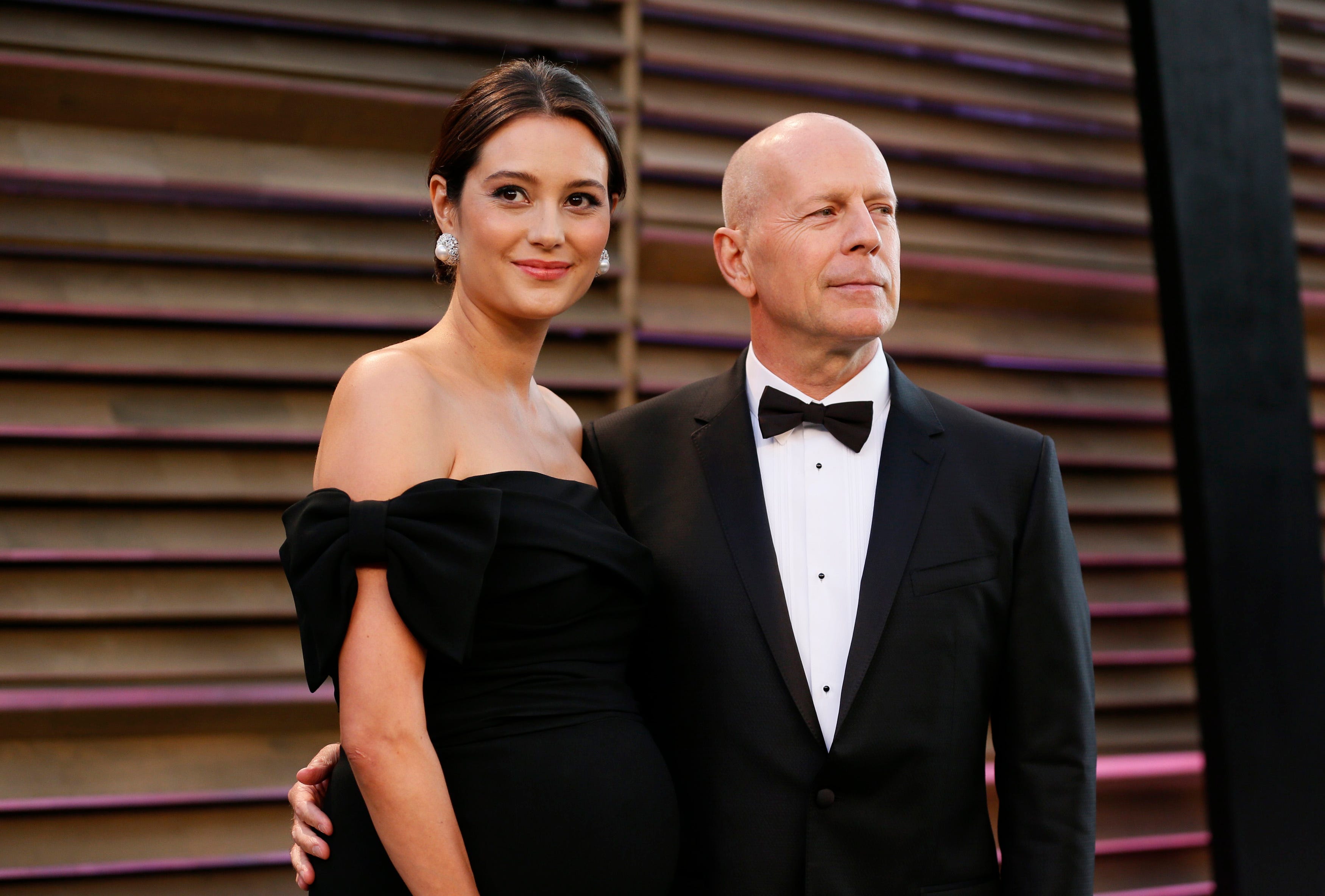 Bruce Willis and his wife Emma Heming Willis arrive at the 2014 Vanity Fair Oscars Party in West Hollywood, California on March 2, 2014.