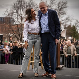 Rep. Alexandria Ocasio Cortez (D-NY) and Senator Bernie Sanders (I-VT) share a moment onstage during a rally on March 21, 2025 at Civic Center Park in Denver, Colorado.