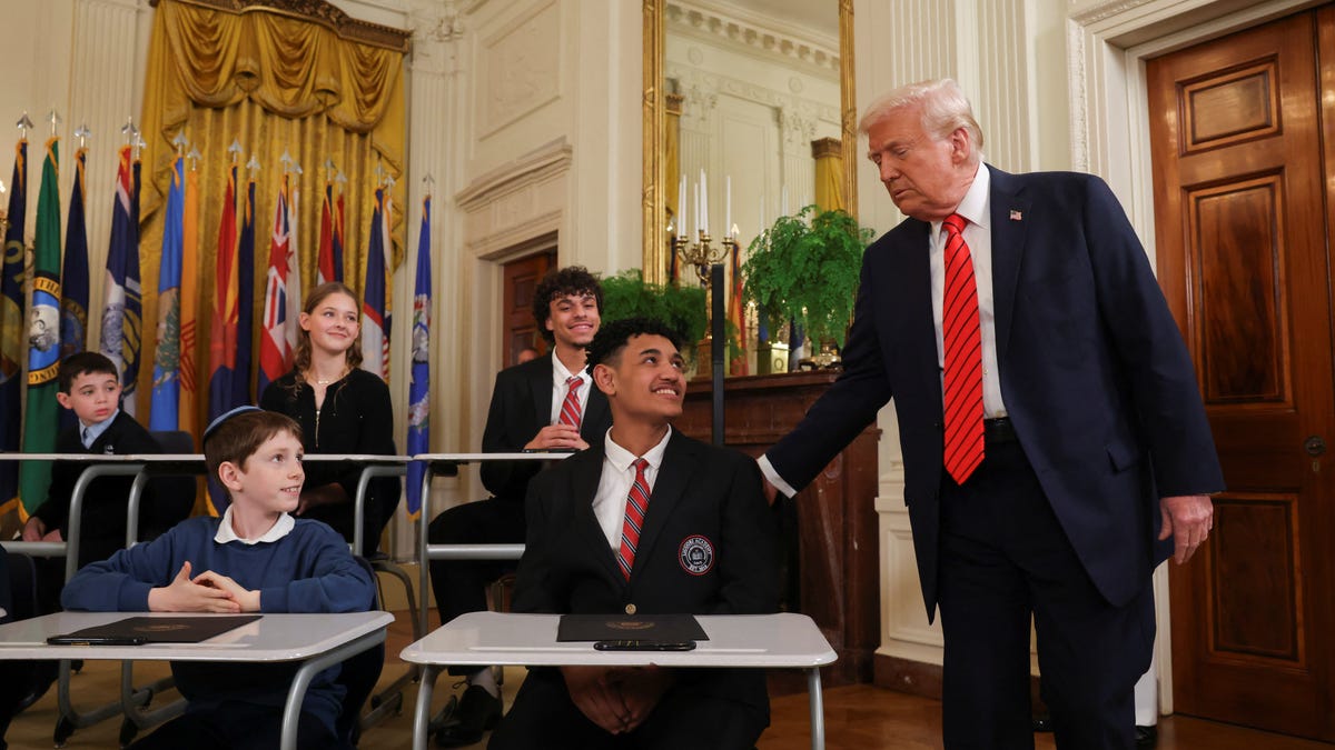 U.S. President Donald Trump greets students during an event to sign an executive order to shut down the Department of Education, in the East Room at the White House in Washington, D.C., U.S., March 20, 2025.