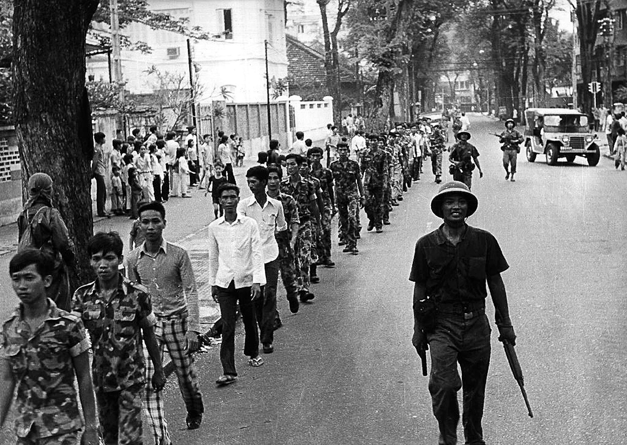 Communist North Vietnamese troops take captured South Vietnamese soldiers to detention on April 30, 1975, in Saigon, renamed Ho Chi Minh City.
