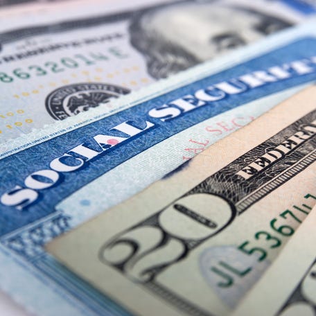 Social security card and American money dollar bills close up concept.