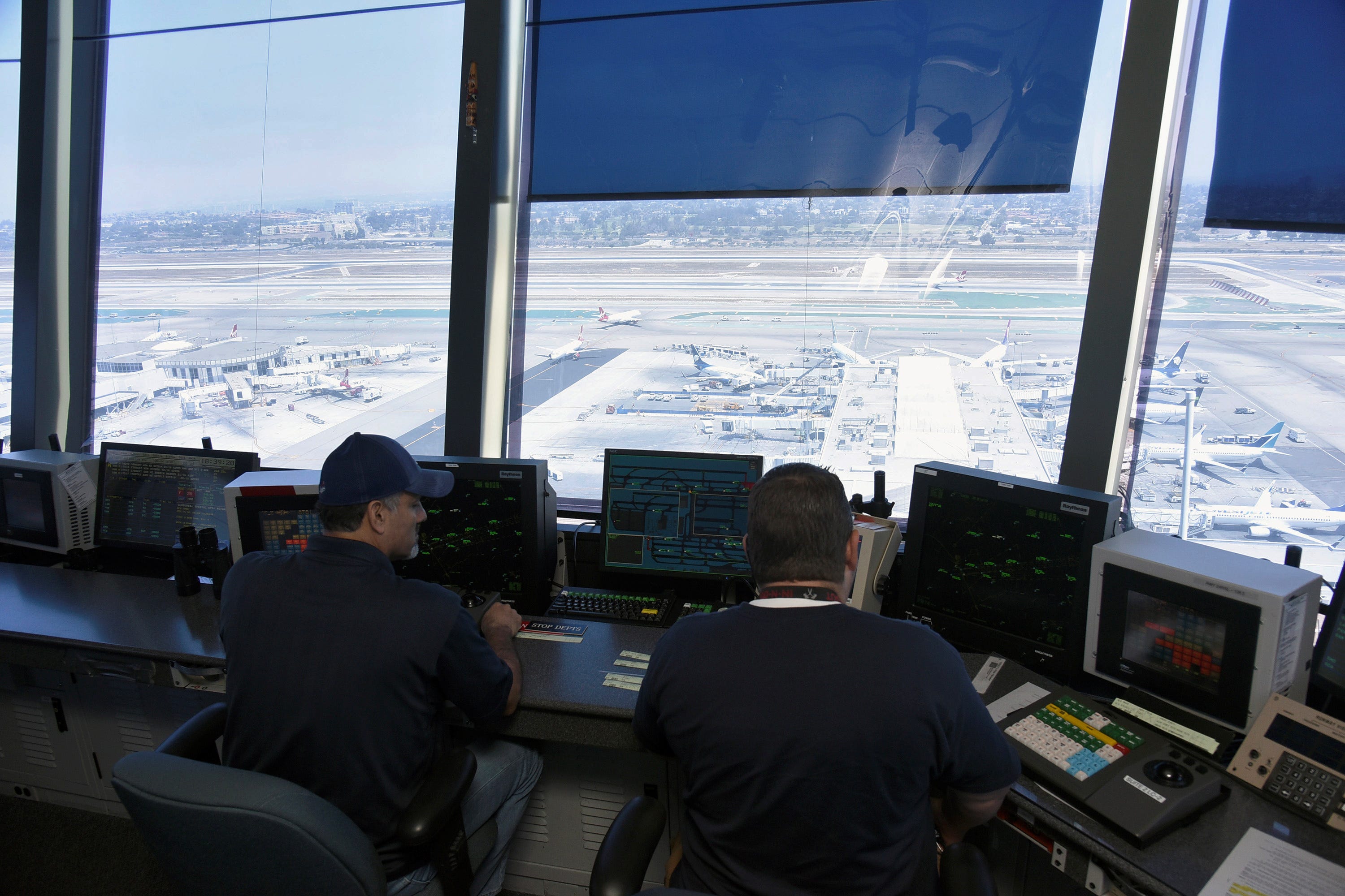 Air traffic controllers talk with pilots inside the control tower at Los Angeles International Airport (LAX) in Los Angeles, California, U.S., June 24, 2016.