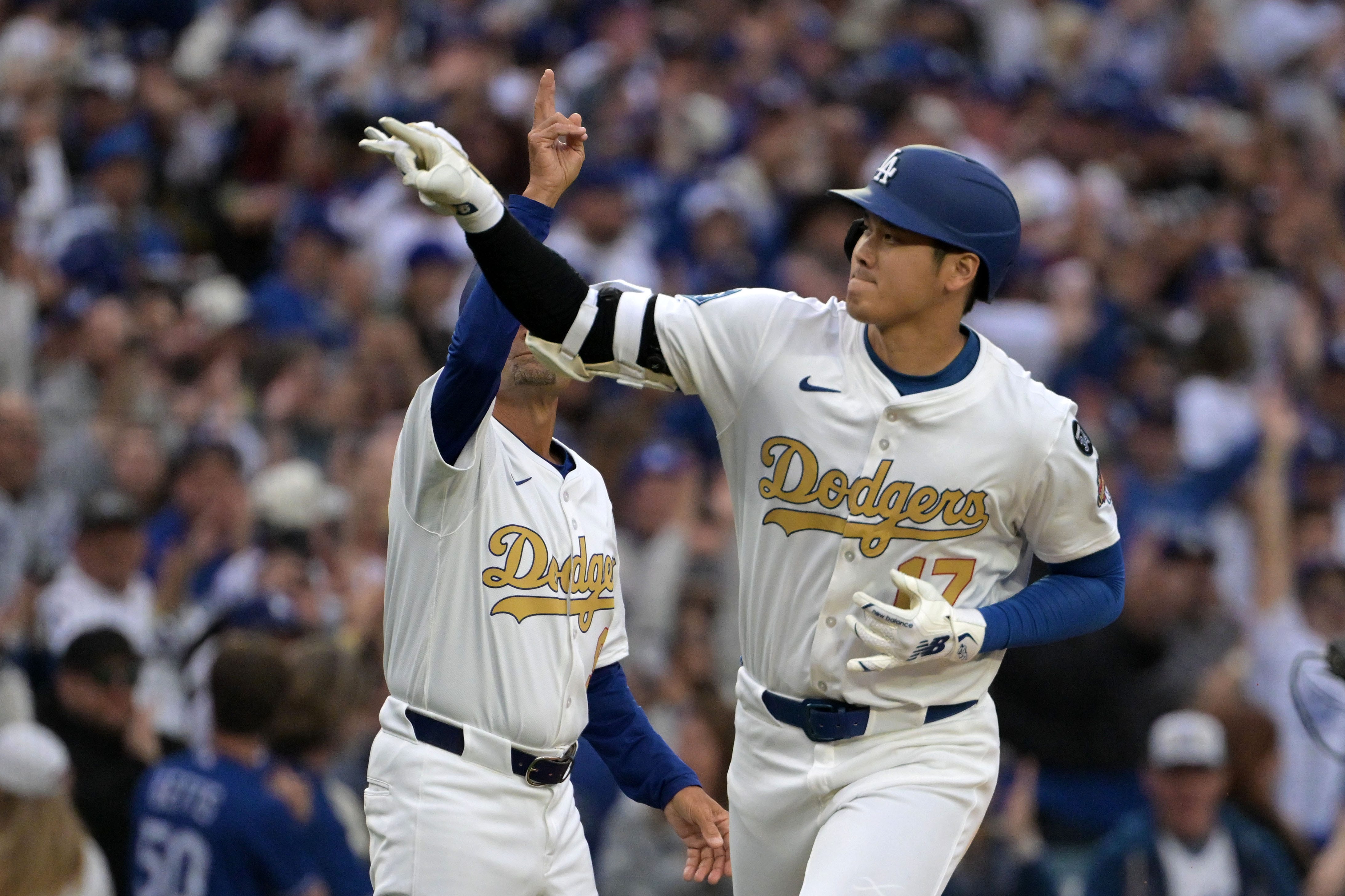 Dodgers two-way player Shohei Ohtani rounds the bases after hitting a solo home run against the Tigers.