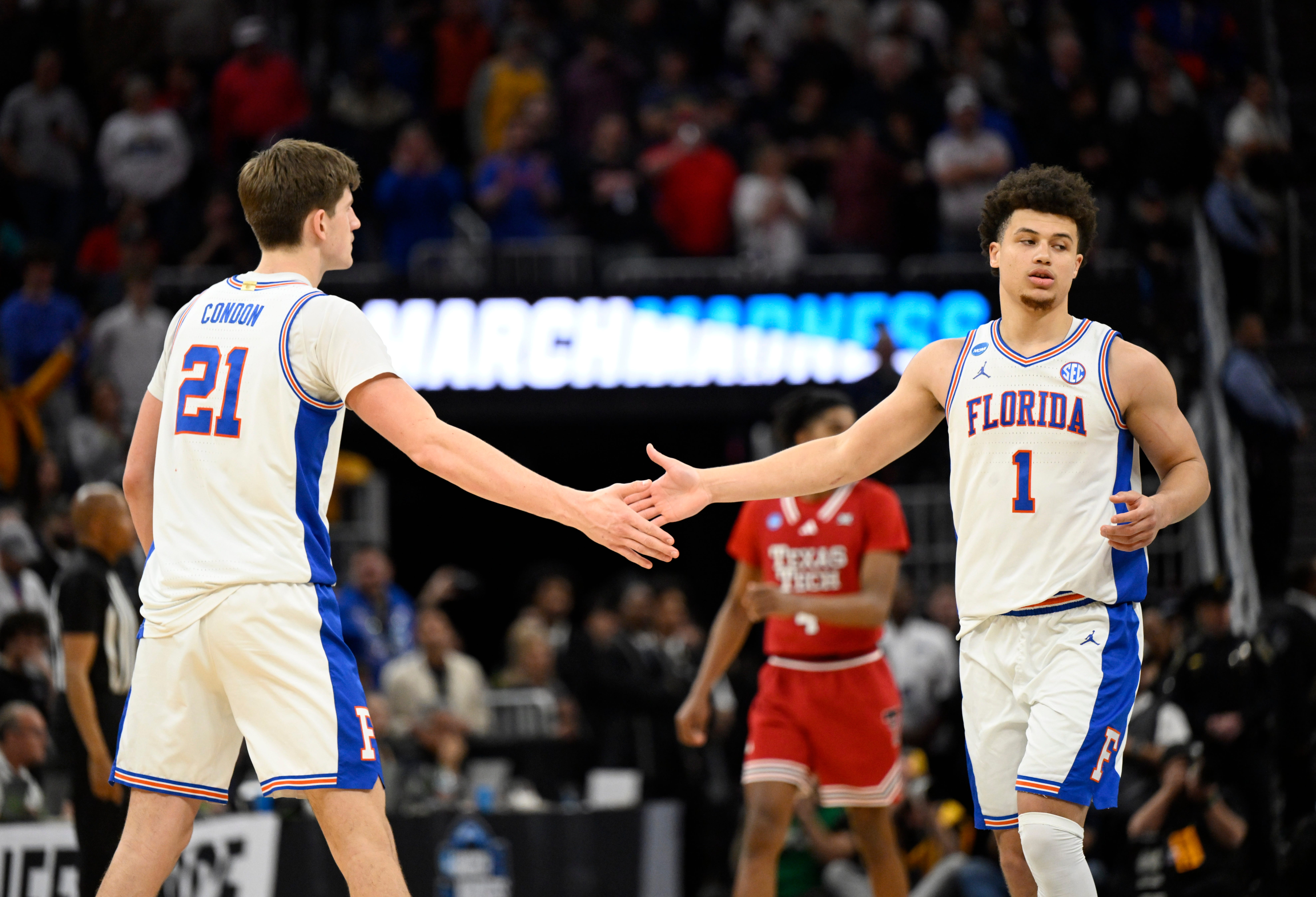 Mar 29, 2025; San Francisco, CA, USA; Florida Gators forward Alex Condon (21) and Florida Gators guard Walter Clayton Jr. (1) high-five during the second half against the Texas Tech Red Raiders during the West Regional final of the 2025 NCAA tournament at Chase Center. Mandatory Credit: Eakin Howard-Imagn Images