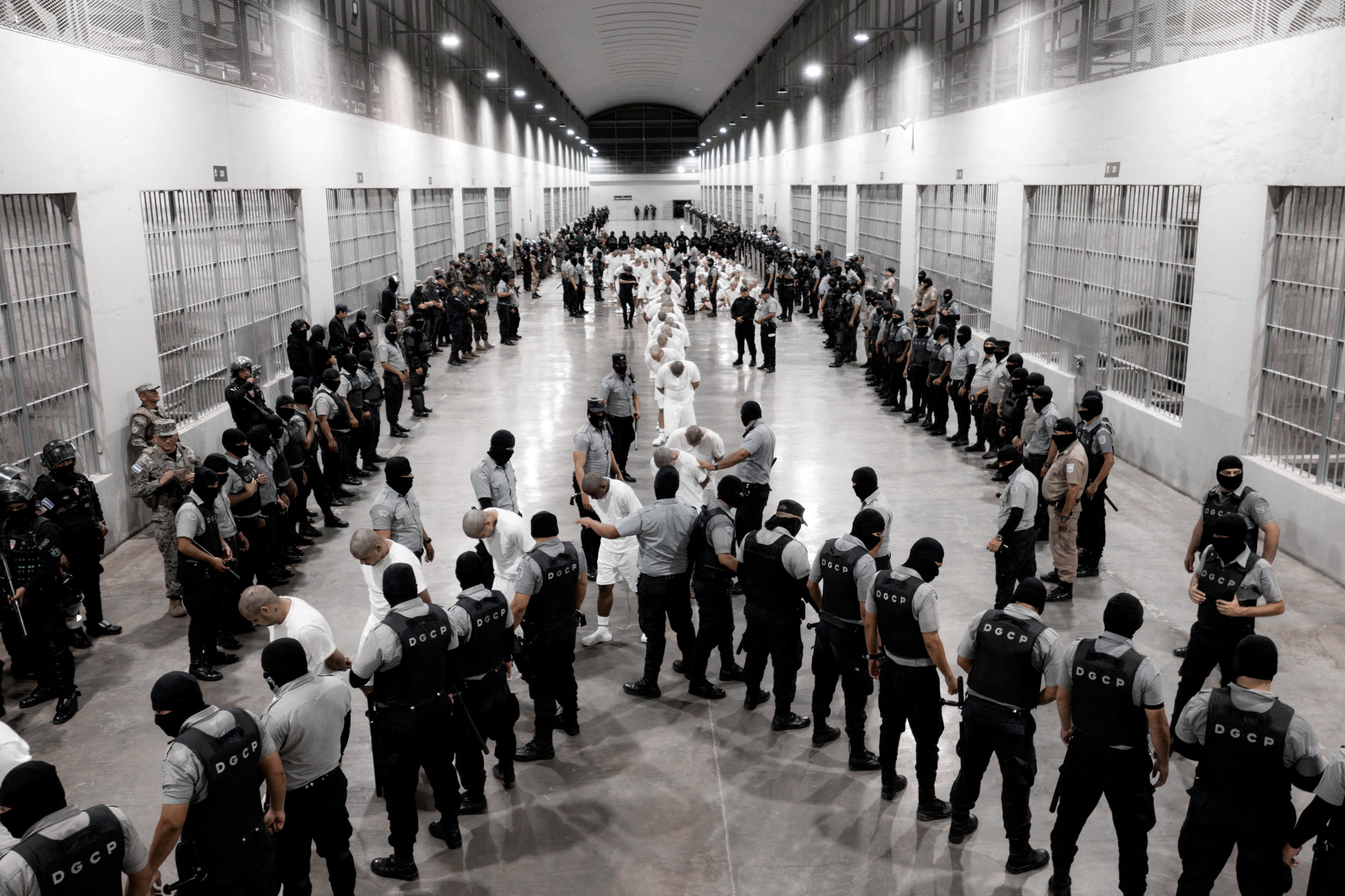 Salvadoran police officers escort alleged members of the Venezuelan gang Tren de Aragua recently deported by the U.S. government to be imprisoned in the Terrorism Confinement Center (CECOT) prison, as part of an agreement with the Salvadoran government, in Tecoluca, El Salvador, in this handout image obtained March 16, 2025.