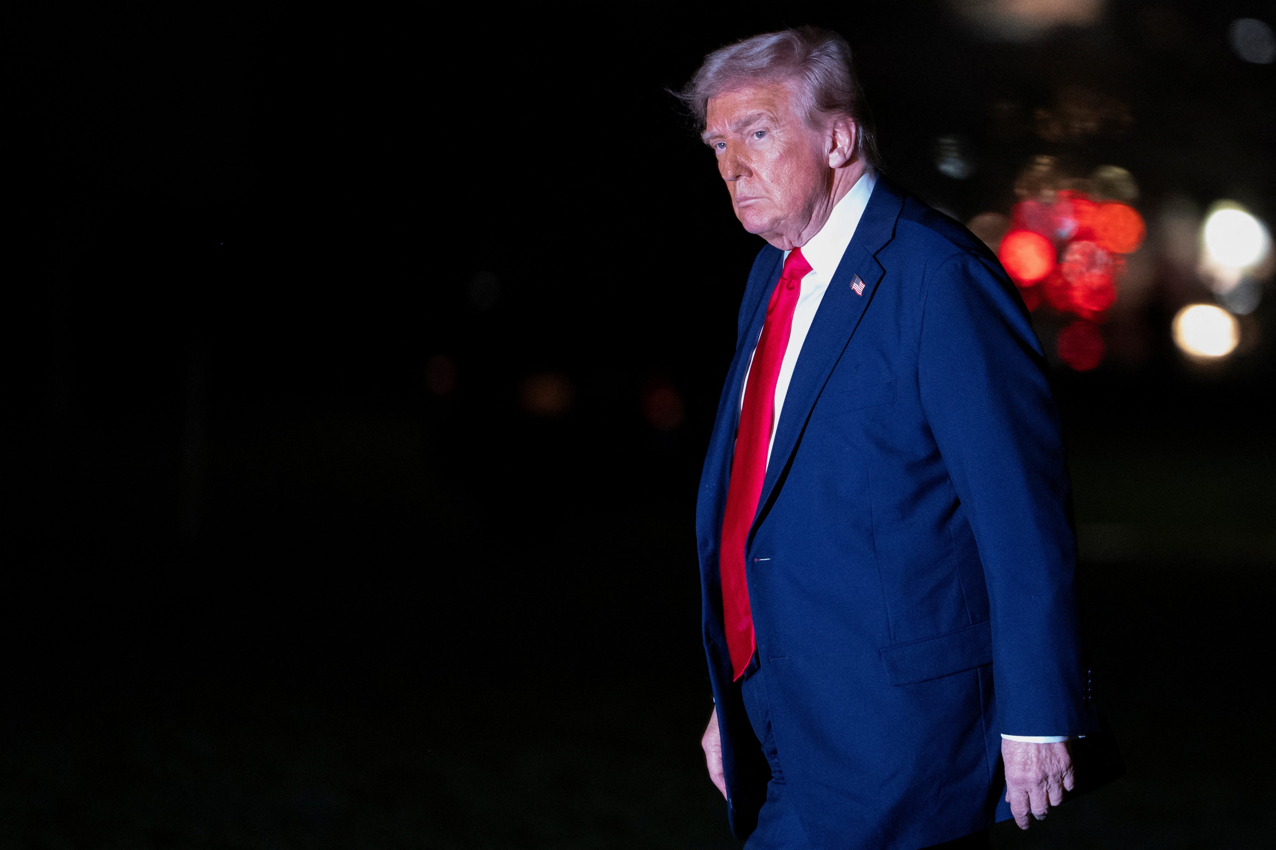 U.S. President Donald Trump walks across the South Lawn while returning to the White House in Washington, D.C., U.S., March 30, 2025. REUTERS/Nathan Howard