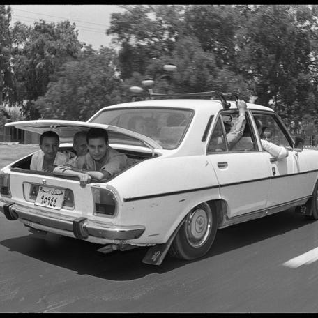 A family drives on its way to Ismailia resort in Cairo to celebrate the muslim feast of Eid Al-Adha on July 12, 1989.