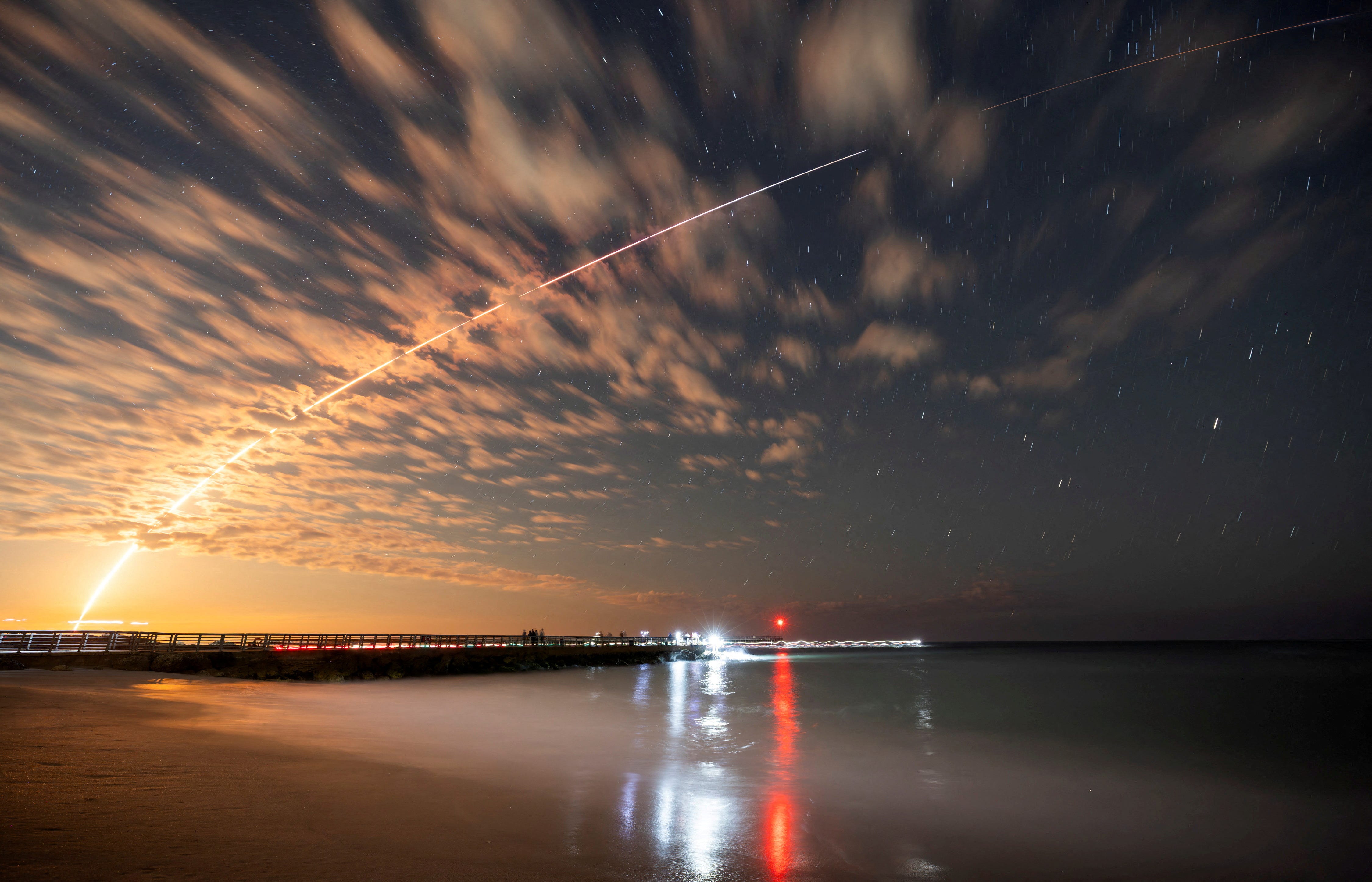 The SpaceX Falcon 9 rocket carrying Starlink satellites is seen over Sebastian Inlet after launching from Cape Canaveral, Florida, U.S., February 26, 2025.