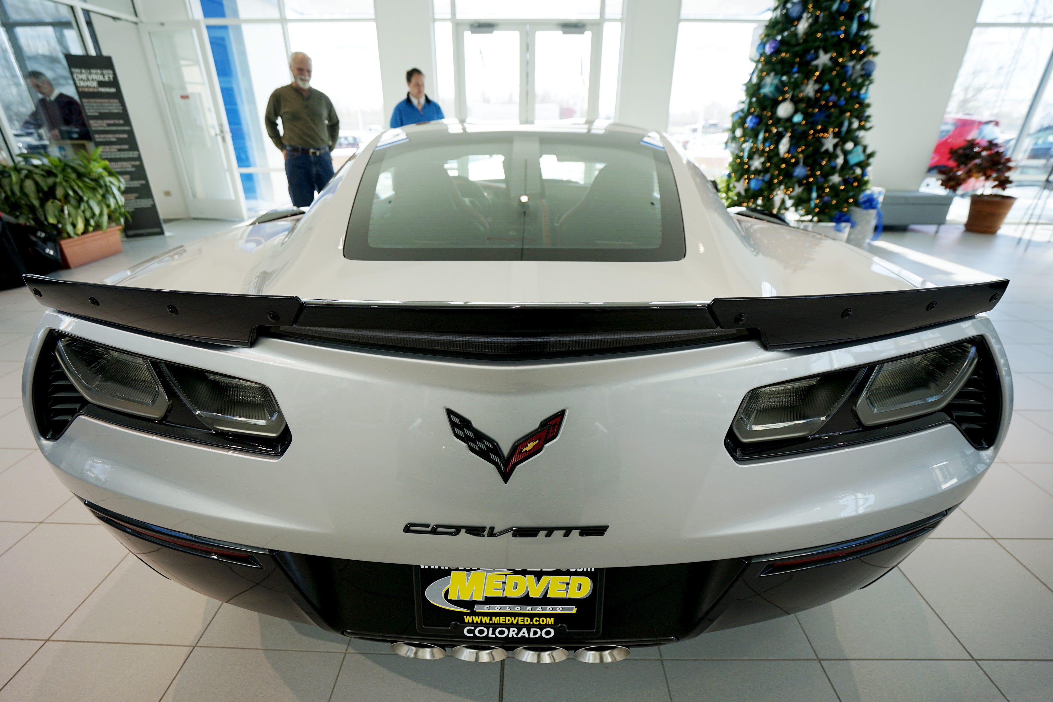 A Chevrolet Corvette Z06 coupe is shown to a customer by a salesperson at dealership in Denver, Colorado.
