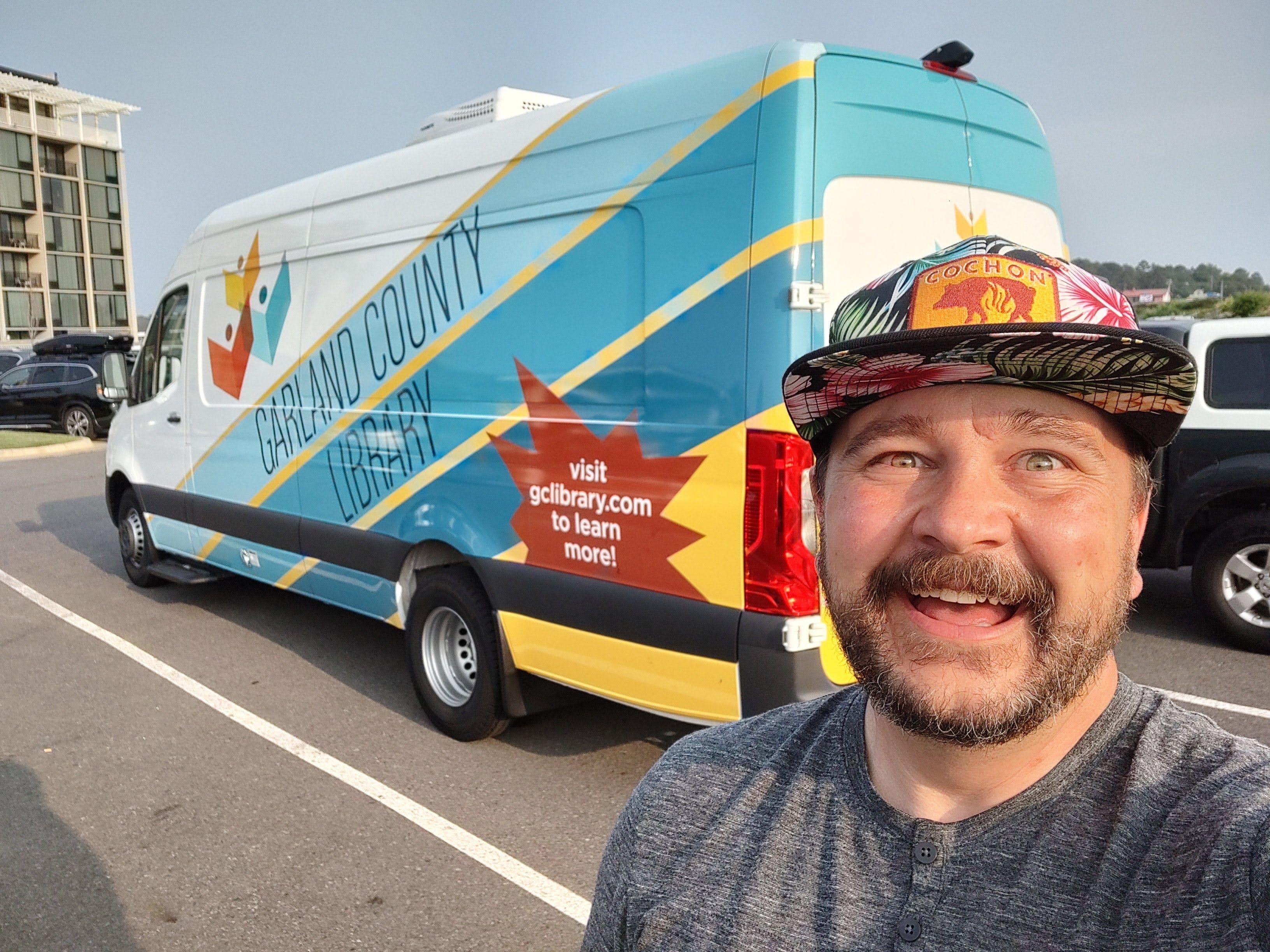 Garland County Library Executive Director Adam Webb poses with a bookmobile purchased with the help of the Institute for Museum and Library Services on June 27, 2023 in Hot Springs, AR