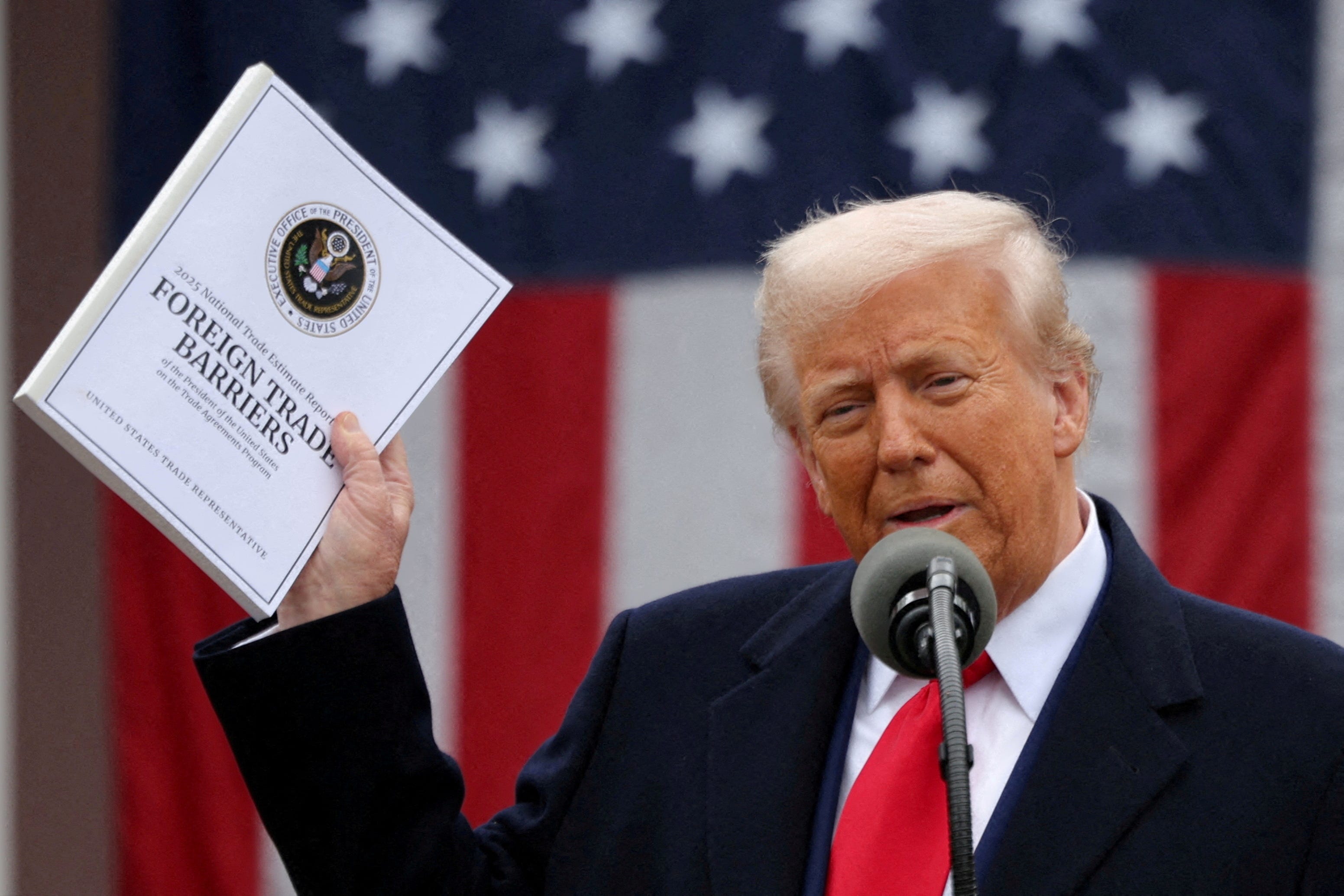 U.S. President Donald Trump holds a "Foreign Trade Barriers" document as he delivers remarks on tariffs in the Rose Garden at the White House in Washington, D.C., U.S., April 2, 2025.