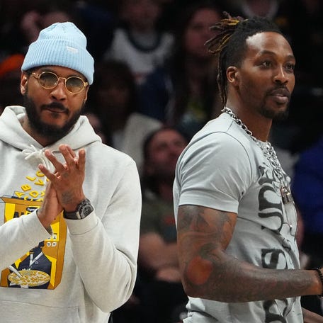 Carmelo Anthony (left) and Dwight Howard (right) cheer the Los Angeles Lakers during a game against the Denver Nuggets on April 10, 2022.