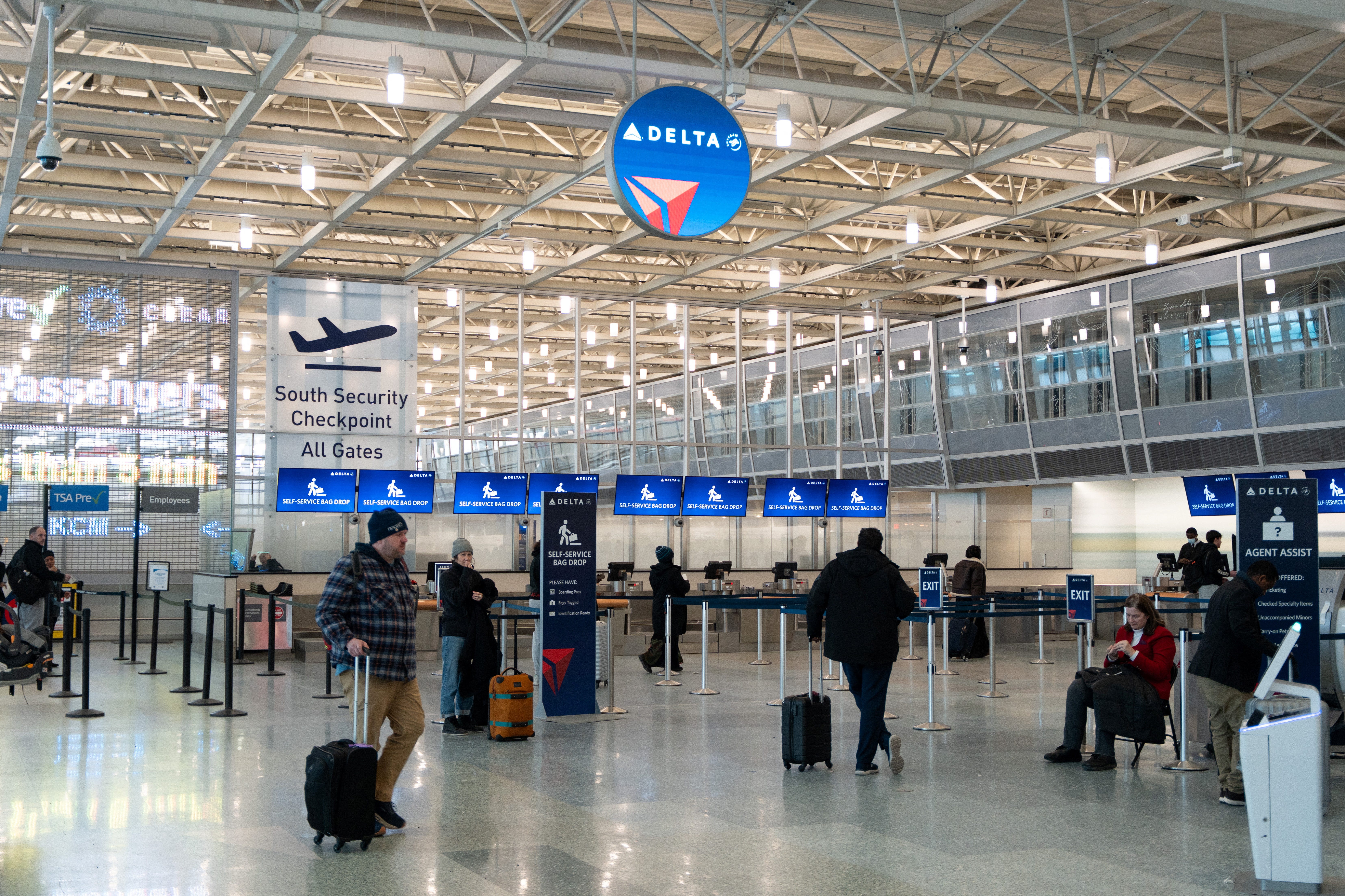 Passengers gather near the Delta Air Lines check-in desk, after a Delta plane which departed Minneapolis crashed at Toronto Pearson International Airport, at Minneapolis–Saint Paul International Airport in St. Paul, Minnesota, U.S. February 17, 2025. REUTERS/Tim Evans
