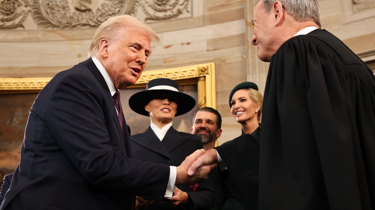 President Donald Trump shakes hands with Supreme Court Chief Justice John Roberts after he was sworn in during inauguration ceremonies in the Rotunda of the US Capitol on January 20, 2025 in Washington, DC.