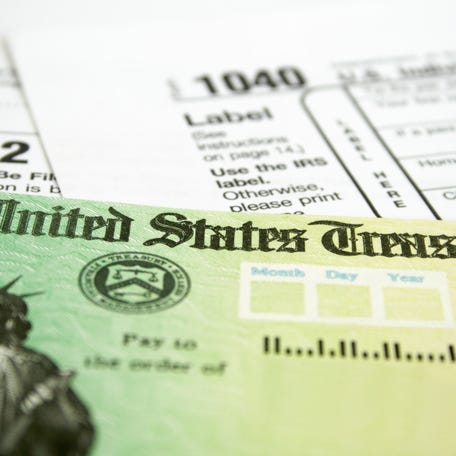 Tax Refund Check with W-2 and 1040 U.S. Individual Income Tax Return Forms