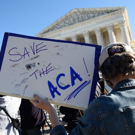 An Affordable Care Act supporter protests at the U.S. Supreme Court on Nov.10, 2020, in Washington, DC.