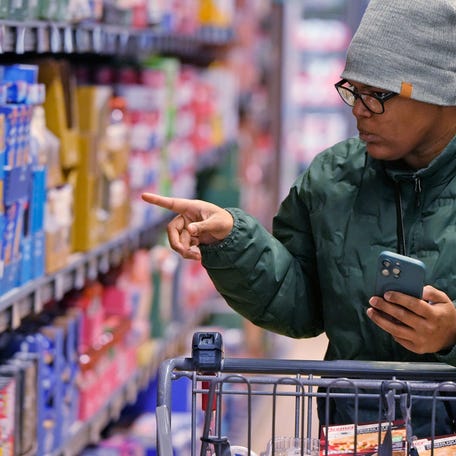 Jontayesha Brown searches through her choices as she grocery shops at the Aldi on Romig Road in Akron, Ohio on Friday Jan. 10, 2025.