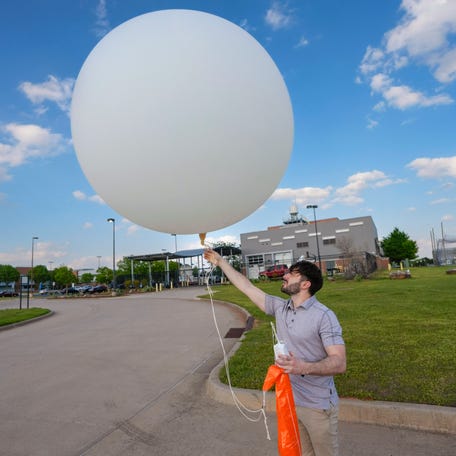 Phillip Ware, a meteorologist at the Norman office of the National Weather Service, launches a weather balloon to launch in Norman, Okla., Wednesday, April 16, 2025. The NWS releases two weather balloons a day.