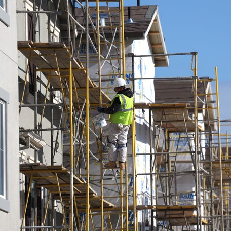 NEWARK, CALIFORNIA - DECEMBER 15: A worker makes repairs to a home under construction at the Lennar Bridgeway home development on December 15, 2021 in Newark, California. Homebuilder Lennar will report fourth quarter earnings today after the closing bell. (Photo by Justin Sullivan/Getty Images)