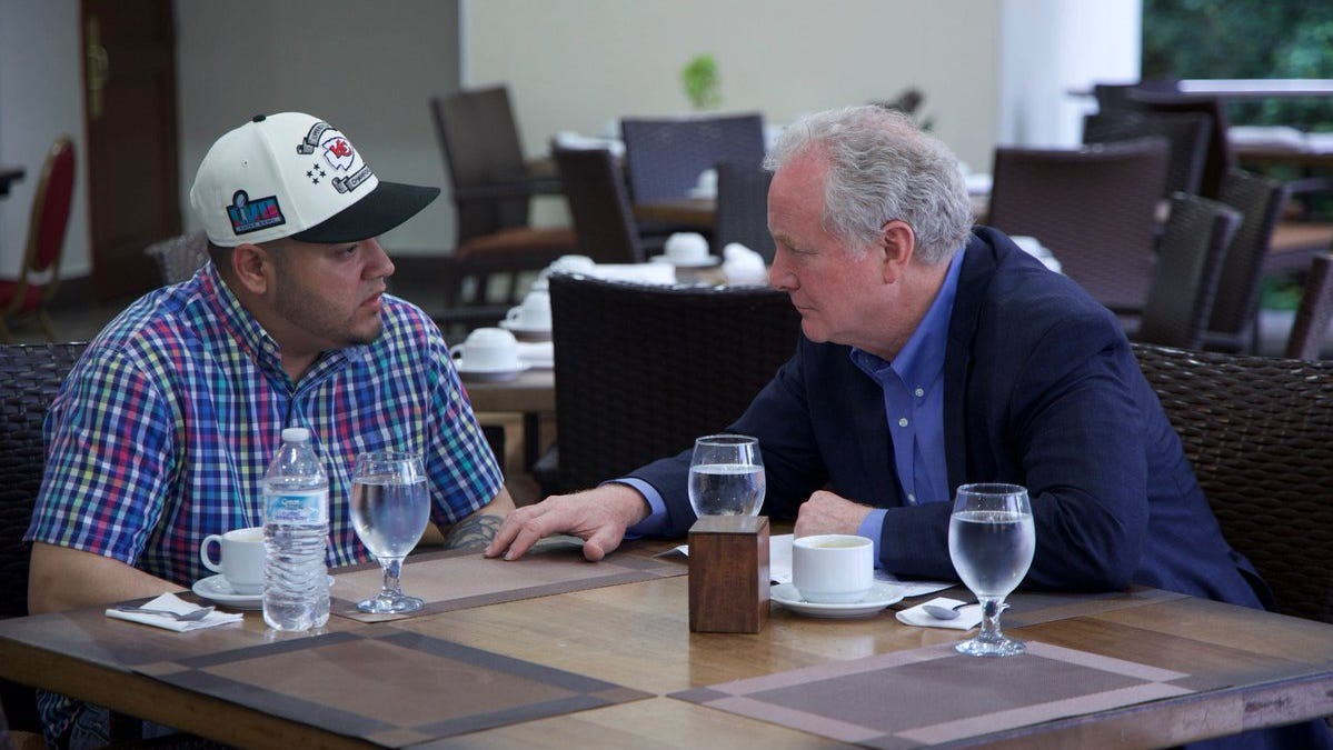 Kilmar Abrego Garcia, left, a Maryland man who was wrongly deported by the Trump administration to El Salvador, and Senator Chris Van Hollen, right, speak with one another on Thursday, April 17, 2025 in El Salvador. Earlier in the day, Van Hollen attempted to visit the prison where Abrego Garcia is being held, but officials denied access.