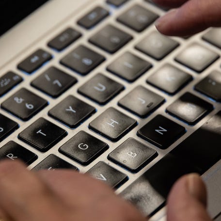 Hands typing on a keyboard