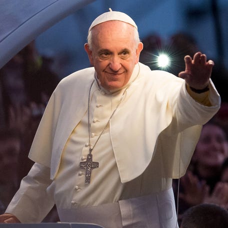 Pope Francis waves from the Popemobile on his way to attend the Via Crucis on Copacabana Beach during World Youth Day celebrations on July 26, 2013 in Rio de Janeiro, Brazil.