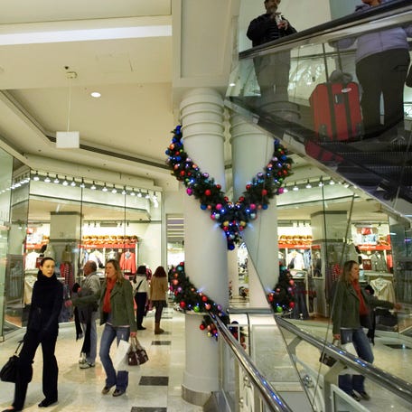 Shoppers walk through the Manhattan Mall in New York. Consumer spending has held up so far despite concerns about tariffs.