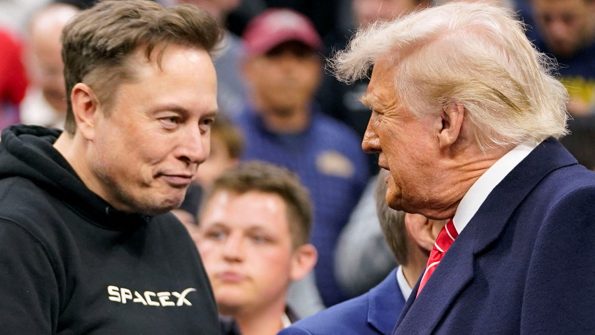 Tesla CEO Elon Musk greets U.S. President Donald Trump as they attend the NCAA men's wrestling championships in Philadelphia, Pennsylvania, U.S., March 22, 2025.