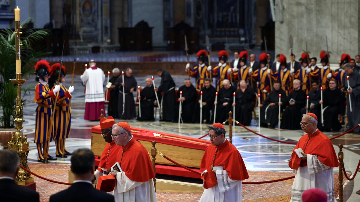 Cardinal Luis Antonio Tagle, Cardinal Pietro Parolin and other Cardinals walk near the coffin containing Pope Francis' body, on the day of the translation of his body, in St. Peter's Basilica at the Vatican, April 23, 2025.