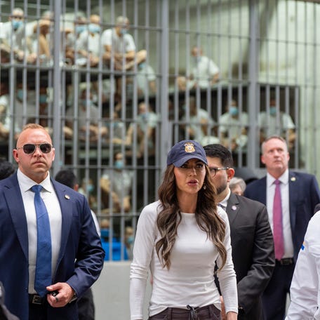 Minister of Justice and Public Security HÃ©ctor Villatoro, right, accompanies Department of Homeland Security Secretary Kristi Noem, center, during a tour of the Terrorist Confinement Center (CECOT) on March 26, 2025 in Tecoluca, El Salvador.