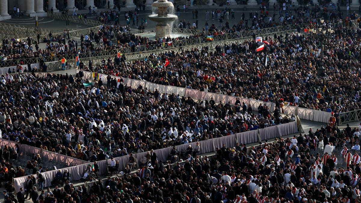 Faithful gather ahead of the funeral Mass for Pope Francis at Saint Peter's Square at the Vatican on April 26, 2025.