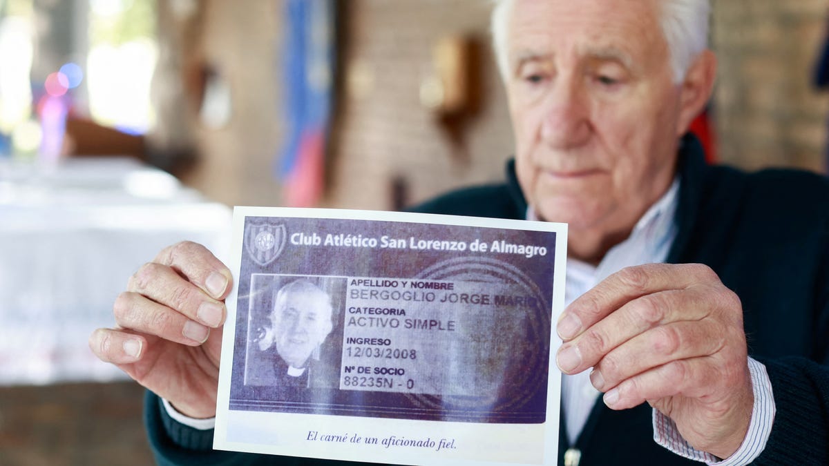 Oscar Lucchini, who is in charge of the chapel of San Lorenzo de Almagro, Pope Francis' hometown soccer team, holds an image of Francis' membership card following his death, in Buenos Aires, Argentina April 21, 2025.