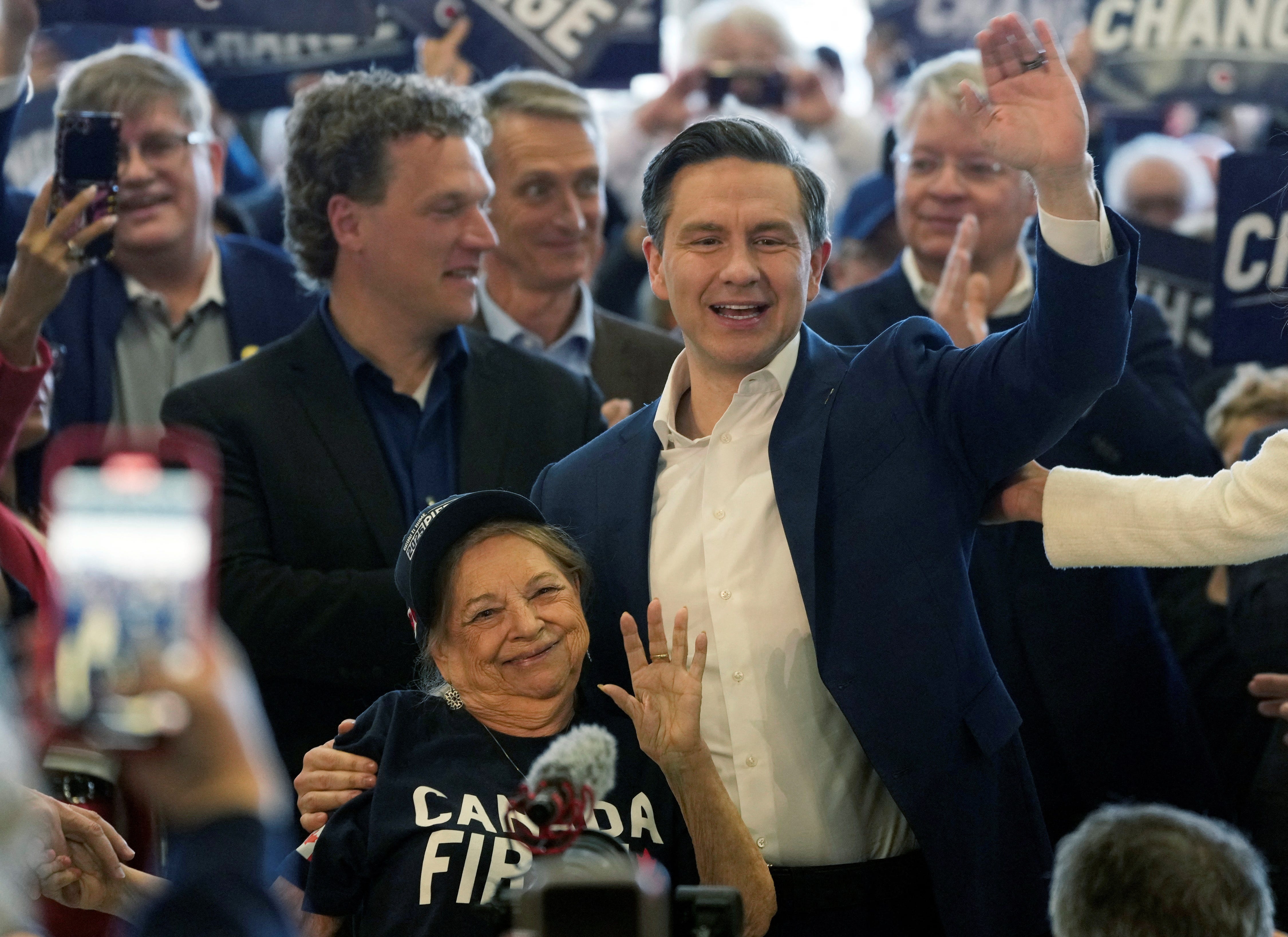 Pierre Poilievre, leader of the Conservative Party of Canada, hugs his mom Marlene Poilievre before addressing supporters at a rally in Calgary, Alberta, Canada April 25, 2025. REUTERS/Todd Korol