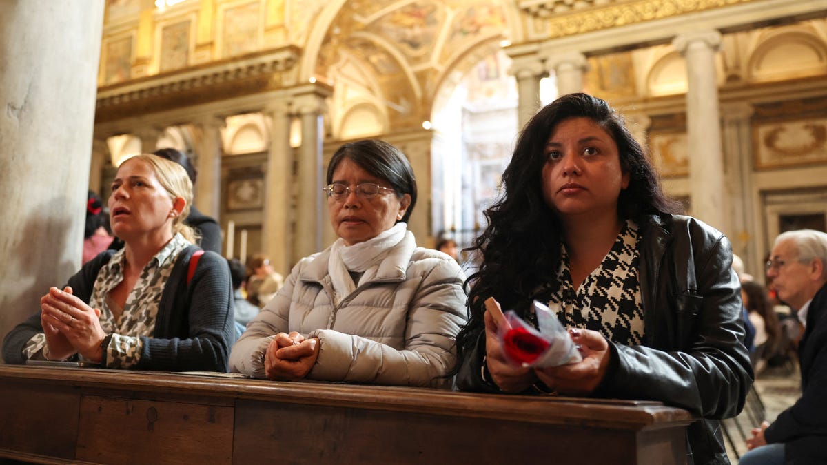 People pray at the Papal Basilica of Saint Mary Major (Santa Maria Maggiore), during a visit to the tomb of the late Pope Francis, in Rome, Italy on April 27, 2025.