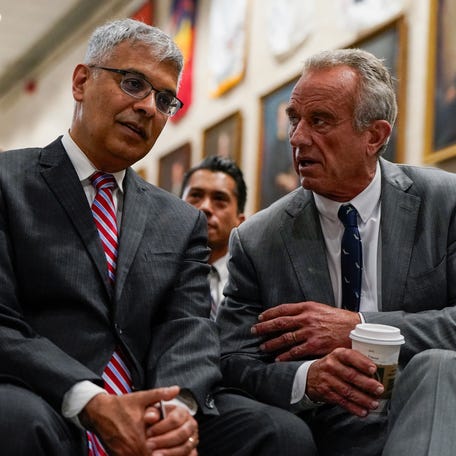 U.S. Health and Human Services (HHS) Secretary Robert F. Kennedy, Jr. speaks with Director of the National Institutes of Health Jay Bhattacharya ahead of a press conference announcing of the U.S. Food and Drug Administration's (FDA) intent to phase out the use of petroleum-based synthetic dyes in the nation's food supply, at the Department of Health and Human Services in Washington, D.C., U.S., April 22, 2025. REUTERS/Elizabeth Frantz