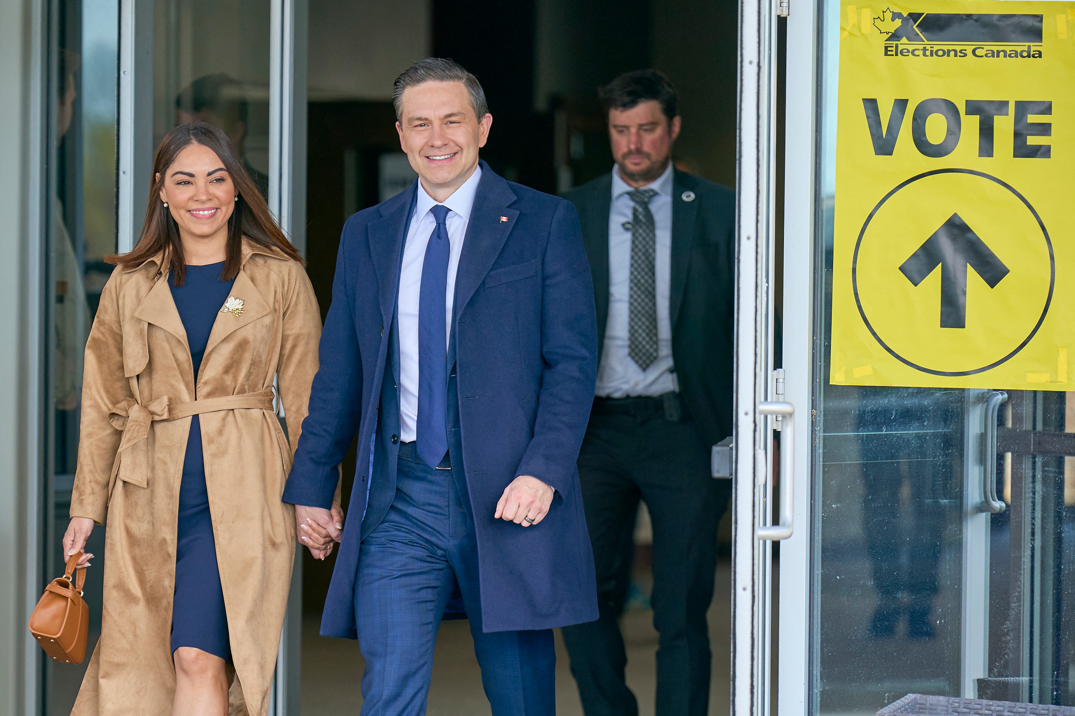 Conservative leader Pierre Poilievre and his wife Anaida depart a polling place after voting in Ottawa, Ontario, Canada on April 28, 2025. Canada was voting Monday for a new government to confront a trade war and annexation threats by President Donald Trump.