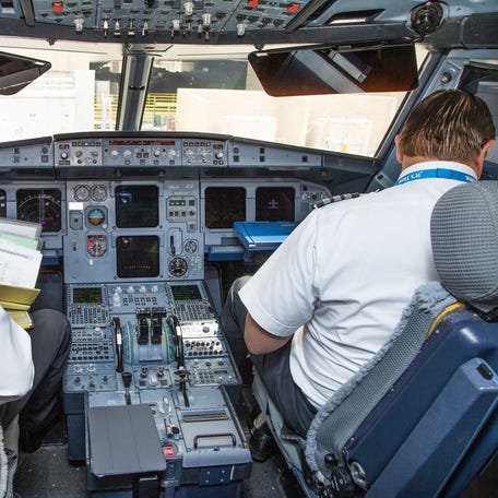 The pilot and co-pilot work in the cockpit after an American Airlines Airbus A-319 landed at Sky Harbor International Airport in Phoenix after a flight from Tucson, Friday, May 10, 2019.