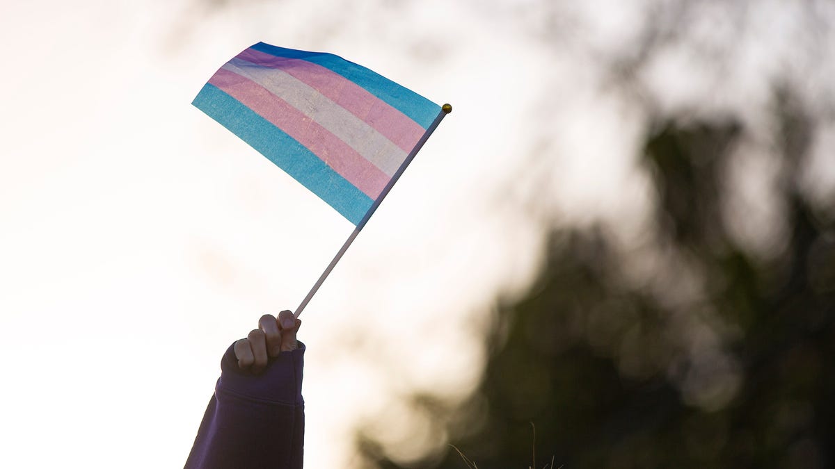 A protester waves a transgender pride flag during a protest against an anti-trans guest speaker on Tuesday, April 4, 2023 at New Mexico State University in Las Cruces, New Mexico.