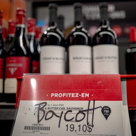 A grafitto calling to boycott an American wine is seen at a liquor store in Montreal, Canada, on February 3, 2025.