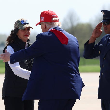 President Donald Trump greets Michigan Gov. Gretchen Whitmer as he arrives in Harrison Township on April 29, 2025.