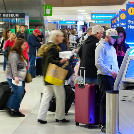 Christmas travelers arrive to bag-check on Christmas Eve at Sky Habor Airport on Dec. 24, 2024, in Phoenix.