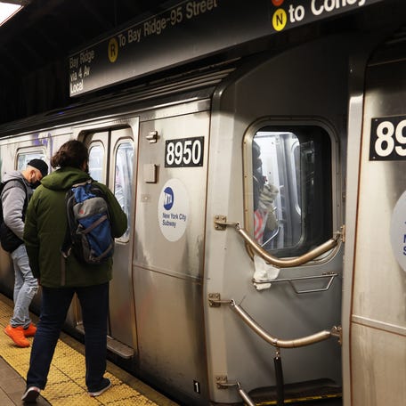 People prepare to enter the R train at the Atlantic Avenue subway station on April 13, 2022 in the Sunset Park neighborhood of Brooklyn in New York City.