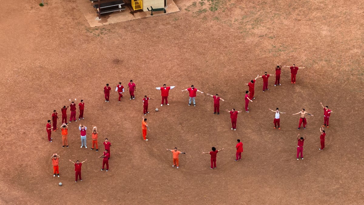 A drone view of detainees forming the letters SOS with their bodies in the courtyard at the Bluebonnet Detention Facility, where Venezuelans at the center of a U.S. Supreme Court ruling are held, in Anson, Texas, April 28, 2025.