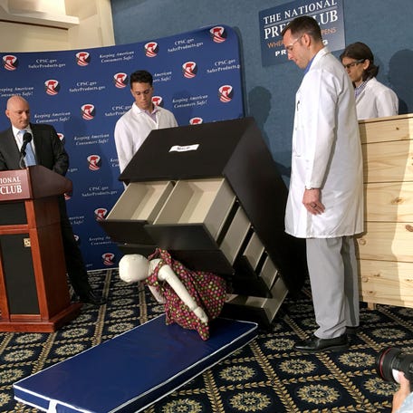 Elliot Kaye (L), chair of the Consumer Product Safety Commission (CPSC) and CPSC employees watch as a 28-pound (13 kilo) dummy(C) falls over and under IKEAs Malm model chest of drawers, during a live demonstration at the National Press Club in Washington, DC on June 28, 2016. Furniture giant Ikea said June 28 it would recall its hugely popular Malm model of chest of drawers in the US and Canada after six children in the US were crushed to death when the chests tipped over. In 2015, Ikea   launched a campaign in the US and Canada to encourage owners of the Malm chests of drawers to anchor them to the wall.