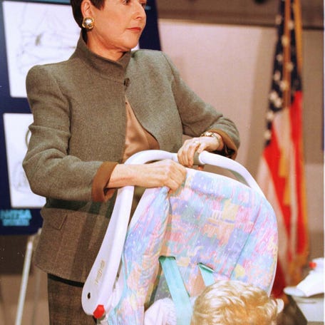 Ann Brown, Chairman of the Consumer Product Safety Commission (CPSC), demonstrates a faulty handle on a car seat, during a press conference in Washington on March 4th, 1998. The National Highway Traffic Safety Administration and the CPSC announced the recall of about 800.000 Evenflo On My Way infant car seats/carriers because of a defect that can cause serious injuries to children while the seats are being used as infant carriers.