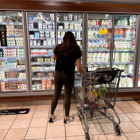 FILE PHOTO: A woman shops in a supermarket as rising inflation affects consumer prices in Los Angeles, California, U.S., June 13, 2022.